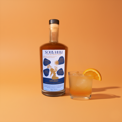 Bottle off Soul Hum Unwind Elixirs with an orange background. 