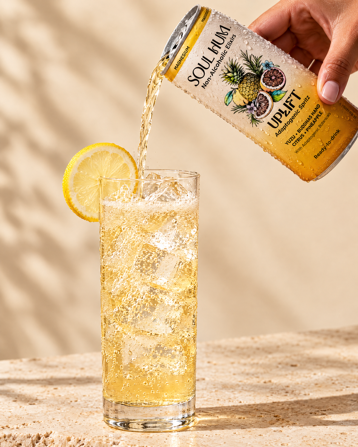 Pouring Uplift Adaptogenic Spritz over ice