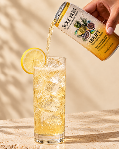 Pouring Uplift Adaptogenic Spritz over ice
