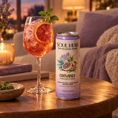 Unwind Adaptogenic Spritz can beside a blood orange spritz at dusk