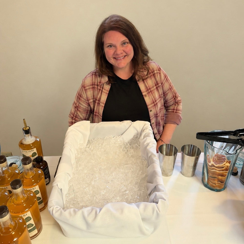 Anna B., founder of Soul Hum Elixirs, at a tasting table
