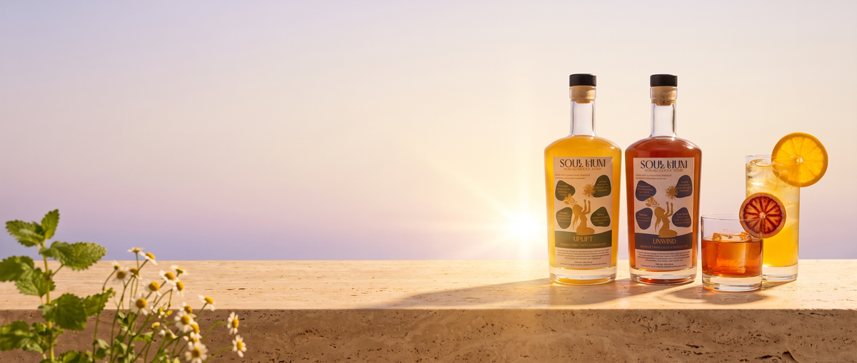Soul Hum Uplift and Unwind elixirs at golden hour on a stone ledge