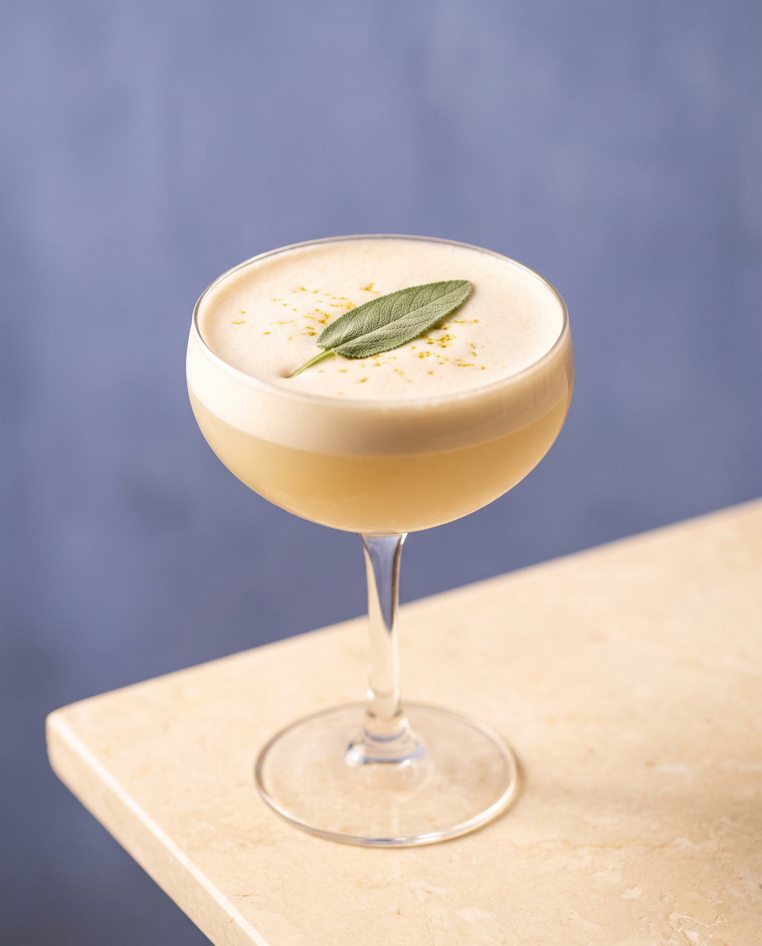 Chinotto Sour made with Soul Hum Unwind elixir, served in a coupe glass with a silky foam cap and sage leaf